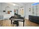 Bright entryway with piano, hardwood floors, and elegant decor at 11910 Climbing Fern Ave, Riverview, FL 33579