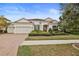 Beautiful one-story home with tile roof and lush landscaping at 11910 Climbing Fern Ave, Riverview, FL 33579