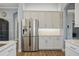 Modern kitchen with stainless steel refrigerator and white shaker cabinets at 11910 Climbing Fern Ave, Riverview, FL 33579
