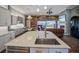 Open concept kitchen with large island, sink, and dishwasher at 11910 Climbing Fern Ave, Riverview, FL 33579