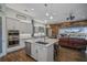 Open concept kitchen with island, stainless steel appliances, and views to pool at 11910 Climbing Fern Ave, Riverview, FL 33579