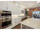 Spacious kitchen featuring double oven, white cabinets, and an island at 11910 Climbing Fern Ave, Riverview, FL 33579