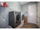 Laundry room with washer and dryer, and additional shelving at 11910 Climbing Fern Ave, Riverview, FL 33579