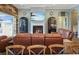 Gathering room with fireplace, leather couches, and pool view at 11910 Climbing Fern Ave, Riverview, FL 33579