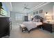 Spacious main bedroom with a large bed, plenty of natural light, and stylish decor at 11910 Climbing Fern Ave, Riverview, FL 33579