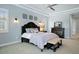 Spacious main bedroom with a king-size bed and decorative wall art at 11910 Climbing Fern Ave, Riverview, FL 33579