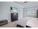 Main bedroom with dresser, large TV and plenty of light at 11910 Climbing Fern Ave, Riverview, FL 33579