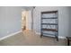 Office with open access to another room and a metal shelving unit at 11910 Climbing Fern Ave, Riverview, FL 33579