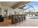 Outdoor kitchen and bar with seating at 11910 Climbing Fern Ave, Riverview, FL 33579