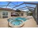 Resort-style pool with spa and covered patio at 11910 Climbing Fern Ave, Riverview, FL 33579