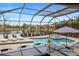 Covered patio with pool, spa, and lake view at 11910 Climbing Fern Ave, Riverview, FL 33579