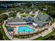 Community clubhouse with pool and surrounding landscape at 1215 Dustan Pl, Trinity, FL 34655