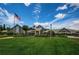 Community clubhouse with American flag and lush green lawn at 1215 Dustan Pl, Trinity, FL 34655