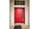 Close-up view of the home's red front door at 1215 Dustan Pl, Trinity, FL 34655