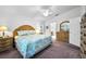 Spacious main bedroom with a king-size bed, ceiling fan, and ensuite bathroom at 1215 Dustan Pl, Trinity, FL 34655