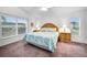 Bright main bedroom with a king-size bed and ample natural light at 1215 Dustan Pl, Trinity, FL 34655