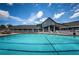 Community pool with lounge chairs and adjacent clubhouse at 1215 Dustan Pl, Trinity, FL 34655