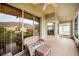 Relaxing screened porch with wicker furniture at 1215 Dustan Pl, Trinity, FL 34655