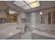 Bathroom with a bathtub, shower, and updated vanity at 12430 81St Pl, Seminole, FL 33772
