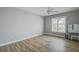 Bedroom with wood flooring, large window and vanity at 12430 81St Pl, Seminole, FL 33772
