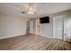 Primary bedroom with ceiling fan, wood-look floors and private bathroom at 12430 81St Pl, Seminole, FL 33772