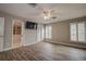 Spacious bedroom with ceiling fan, wood-look floors and private bathroom at 12430 81St Pl, Seminole, FL 33772