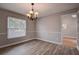 Bright dining room with chandelier and wood-look floors at 12430 81St Pl, Seminole, FL 33772