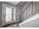 Entryway with white door, wood-look floors and staircase at 12430 81St Pl, Seminole, FL 33772