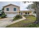Front view of a two-story house with a large lawn at 12430 81St Pl, Seminole, FL 33772