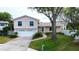 Two-story house with attached garage and landscaped lawn at 12430 81St Pl, Seminole, FL 33772