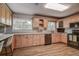 Well-equipped kitchen with light wood cabinets and granite countertops at 12430 81St Pl, Seminole, FL 33772