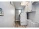 Bright laundry room with washer, dryer, and storage cabinets at 12430 81St Pl, Seminole, FL 33772