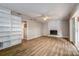 Living room with built-in shelving, fireplace, and wood-look floors at 12430 81St Pl, Seminole, FL 33772