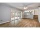 Spacious living room with wood-look floors, built-in shelving, and fireplace at 12430 81St Pl, Seminole, FL 33772