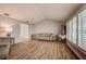 Living room with vaulted ceiling, wood floors, and large window at 12430 81St Pl, Seminole, FL 33772
