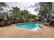 Inviting kidney-shaped pool with lounge chairs and patio at 12430 81St Pl, Seminole, FL 33772