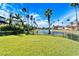 Grass backyard with a lake view and fence at 1308 Alhambra Dr, Apollo Beach, FL 33572