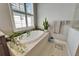 Relaxing bathroom with a free-standing bathtub and plenty of plants at 1308 Alhambra Dr, Apollo Beach, FL 33572