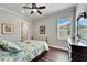 Bright bedroom with ceiling fan, window shutters, and wood floors at 1308 Alhambra Dr, Apollo Beach, FL 33572