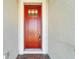 Front entry with a red door and brick flooring at 1308 Alhambra Dr, Apollo Beach, FL 33572