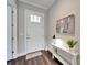 Elegant entryway with white door and console table at 1308 Alhambra Dr, Apollo Beach, FL 33572