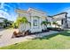 Side view of Mediterranean home showcasing landscaping and garage at 1308 Alhambra Dr, Apollo Beach, FL 33572