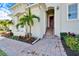 Inviting exterior featuring a red door and landscaped walkway at 1308 Alhambra Dr, Apollo Beach, FL 33572