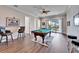 Game room features a pool table, bar stools, and access to a balcony at 1308 Alhambra Dr, Apollo Beach, FL 33572