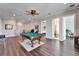 Game room with pool table, hardwood floors, and views into other rooms at 1308 Alhambra Dr, Apollo Beach, FL 33572