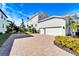 Two-car garage with paver driveway and nicely landscaped surroundings at 1308 Alhambra Dr, Apollo Beach, FL 33572