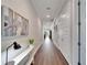 Bright hallway with wood floors and coastal art at 1308 Alhambra Dr, Apollo Beach, FL 33572