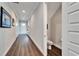 Bright hallway with wood flooring and access to powder room at 1308 Alhambra Dr, Apollo Beach, FL 33572