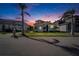 Luxury home exterior at dusk with palm trees at 1308 Alhambra Dr, Apollo Beach, FL 33572