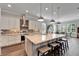 Spacious kitchen with granite island, stainless steel appliances, and hardwood floors at 1308 Alhambra Dr, Apollo Beach, FL 33572